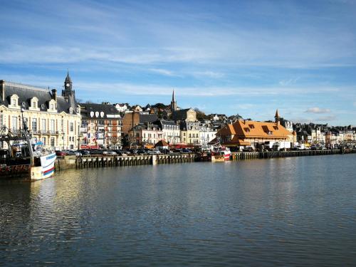 a large body of water with buildings and a city at Study du pêcheur in Trouville-sur-Mer