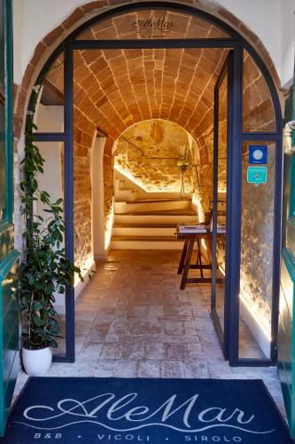 a hallway with an archway and stairs in a building at AleMar Sirolo in Sirolo