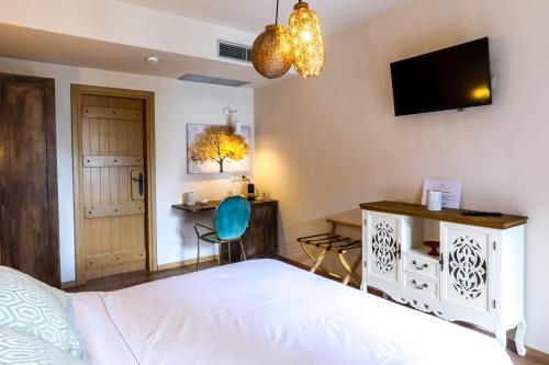 a bedroom with a bed and a tv on the wall at Mythic Valley in Litochoro