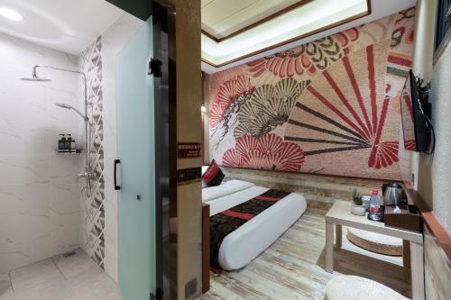 a bathroom with a bed in a room at Zou Qu Ye Travel Hotel in Chongqing