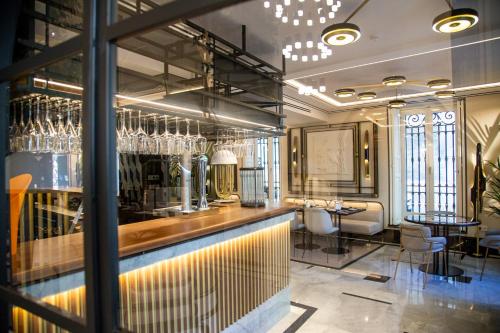 a bar in a restaurant with glasses on the wall at MYR Palacio Vallier in Valencia