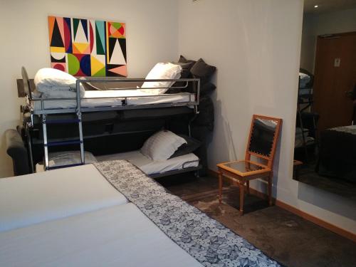 a room with two bunk beds and a chair at Hotel Aida Opera in Paris