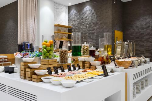 a buffet of food on a table in a room at Mercure Sohar in Sohar
