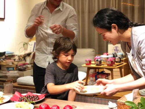 a woman offering a child a plate of food at Zen Tea House Seven Stars Park in Guilin