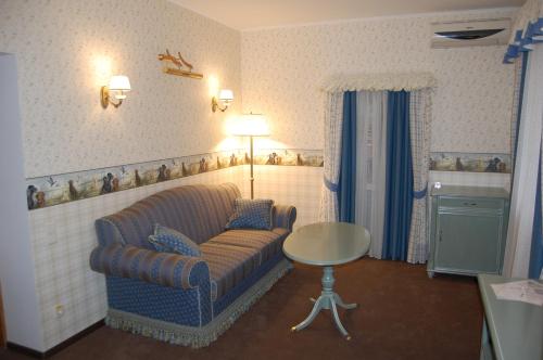 a living room with a couch and a table at Готель Баварія in Poltava