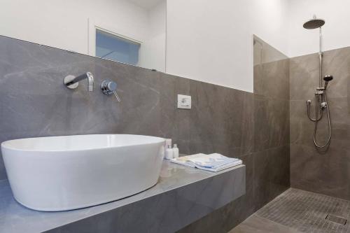 a bathroom with a white tub and a shower at La casa di Nonna Maria in Catania