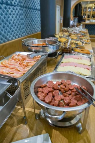 a buffet line with many different types of food at Pantelidis Hotel & Spa in Ptolemaida