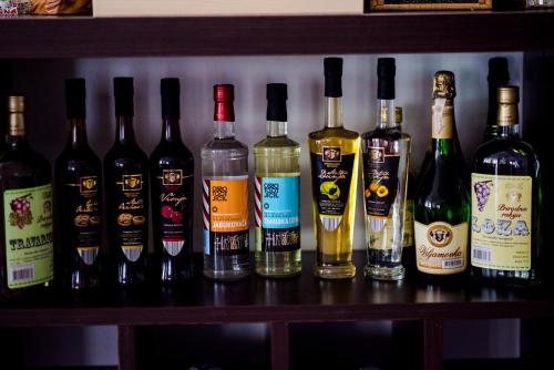 a group of bottles of wine sitting on a shelf at Hotel Villa Monako in Međugorje