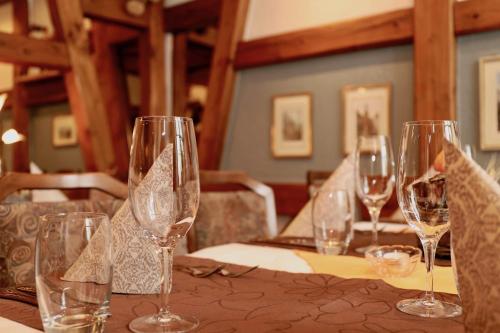 a group of wine glasses sitting on a table at Hotel-Restaurant Weisses Kreuz in Breitenbach