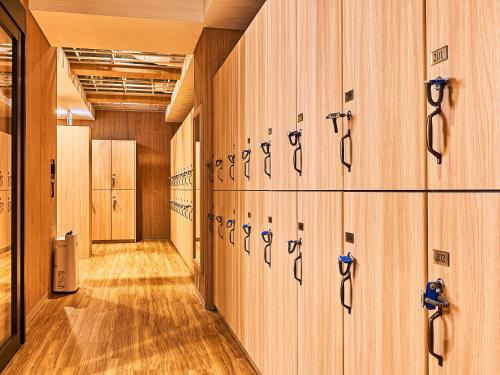 a row of lockers in a gymnasium at Anshin Oyado Woman&Man Nagoya Sakae in Nagoya