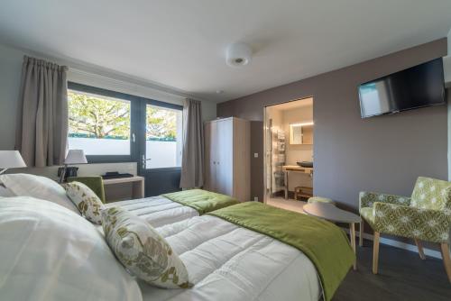 a bedroom with two beds and a living room at Résidence les Dombes in Rillieux