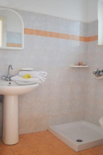 a bathroom with a sink and a shower at XIDIS in Laganas