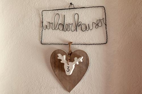 a heart ornament hanging on a wall with the word valhalla at Haus Margreth in Ellmau