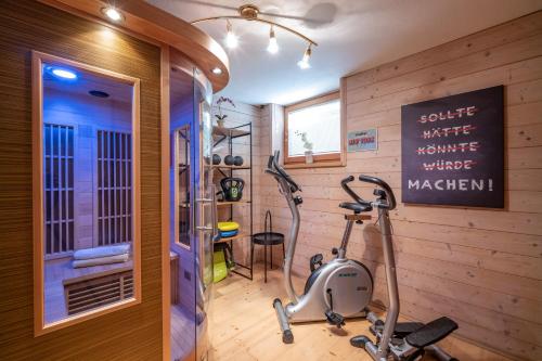 a fitness room with a treadmill and a gym at Haus Margreth in Ellmau