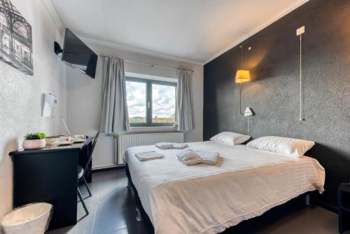 Postel nebo postele na pokoji v ubytování Hôtel de la Gare