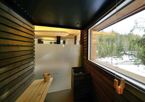 a small bathroom with a window and a tub at Caravan Park Sexten in Sesto