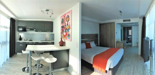 Cet appartement comprend une chambre avec un lit et une cuisine avec un comptoir. dans l'établissement Appart' Hotel La Girafe Marseille Est - Porte d'Aubagne, à La Penne-sur-Huveaune