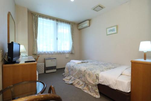 Postel nebo postele na pokoji v ubytování Hotel Tensui