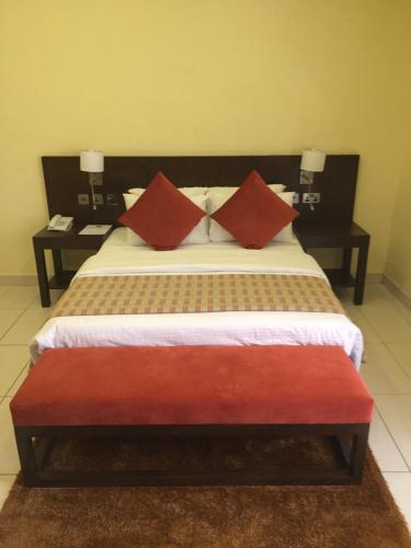 A bed or beds in a room at AMOR Hotels Ekiti
