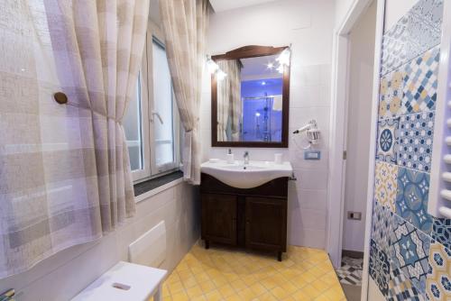 a bathroom with a sink and a mirror at LE BERCEAU in Naples