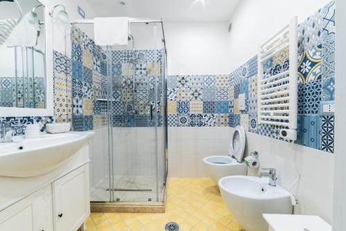 a bathroom with a shower and a sink and a toilet at LE BERCEAU in Naples