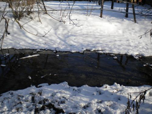 a creek in the snow with snow covered ground at Villa Mainardi Agriturismo in Camino al Tagliamento