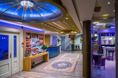 a store lobby with a blue ceiling and a rug at Pantelidis Hotel & Spa in Ptolemaida