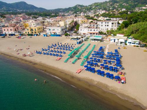 an aerial view of a beach with chairs and umbrellas at Hotel La Villarosa Terme in Ischia