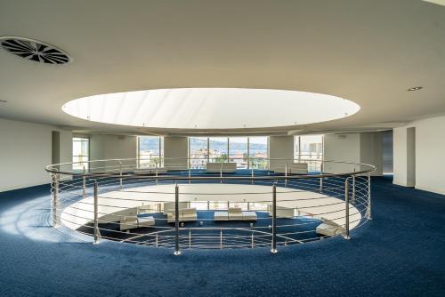 a large room with a large bed in a building at Capo Peloro Hotel in Torre Faro