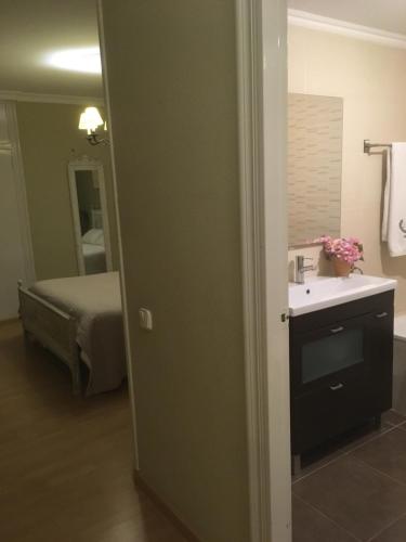 1 dormitorio con 1 cama y baño con lavabo. en Abrigall II, en Cambrils