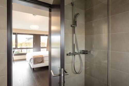 a bathroom with a shower with a glass door at Hotel Lo! im Kreuz Jona in Rapperswil-Jona