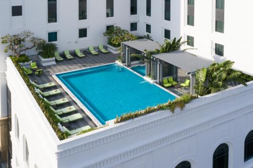 an overhead view of a swimming pool on the roof of a building at Mai House Saigon Hotel in Ho Chi Minh City