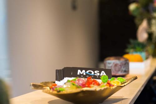 a plate of pizza sitting on a table at Hôtel Mosa in Hermalle-sous-Argenteau