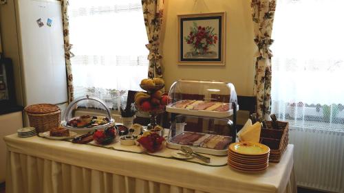 a table with a buffet of food on it at Pensiunea Lucia in Sfântu-Gheorghe