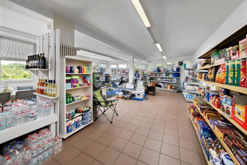 a store aisle of a pharmacy with a lot of products at KNAUS Campingpark Hennesee in Meschede