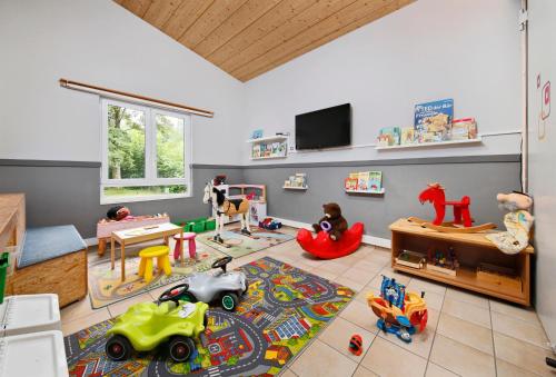a childs room with toys on the floor at KNAUS Campingpark Hennesee in Meschede