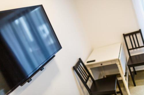 a flat screen tv hanging on a wall at Restaurace a penzion Pod Lipami Metylovice in Metylovice