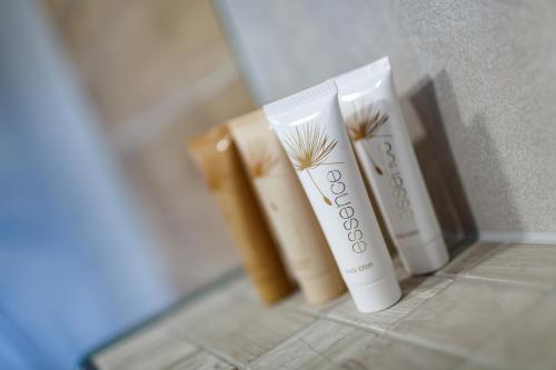 a group of three products sitting on a bathroom floor at Restaurace a penzion Pod Lipami Metylovice in Metylovice