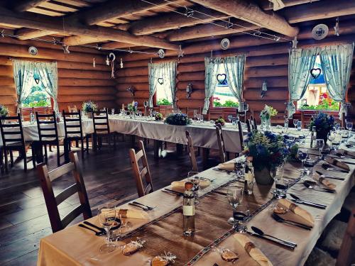 a large dining room with long tables and chairs at Koliba Pod Skalami in Súľov-Hradná