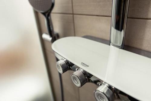 a white sink in a bathroom with a mirror at Hotel Vila Pohorje in Slovenj Gradec