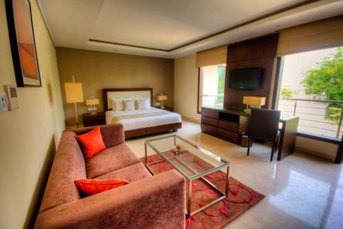 a living room with a couch and a bed at 76 Friends Colony in New Delhi