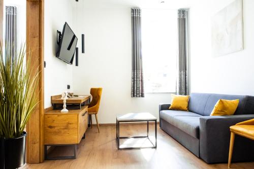 a living room with a couch and a table at Hotel Vila Pohorje in Slovenj Gradec