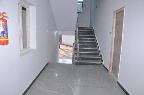 a staircase in a white building with a stair case at Home to explore Food, History & Shopping in Hyderabad
