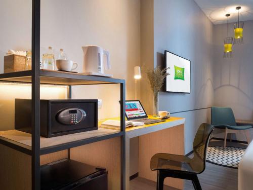 a room with a desk with a computer and a laptop at ibis Styles Bangkok Sukhumvit Phra Khanong in Bangkok