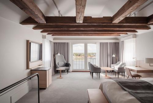 a bedroom with a bed and a desk and chairs at Copenhagen Admiral Hotel in Copenhagen