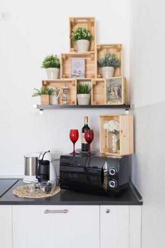 a kitchen counter with a coffee maker on a stove at Il Giuelìn Malpensa B&B in Case Nuove