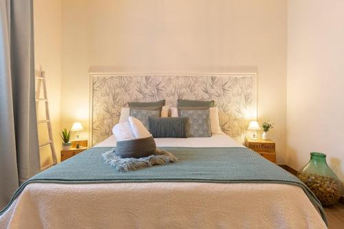 a bedroom with a large bed with a large headboard at Il Giuelìn Malpensa B&B in Case Nuove