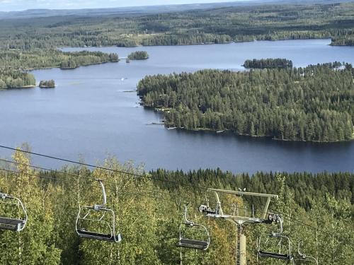 a ski lift with a view of a lake at Tahko Chalet B 601 in Tahkovuori