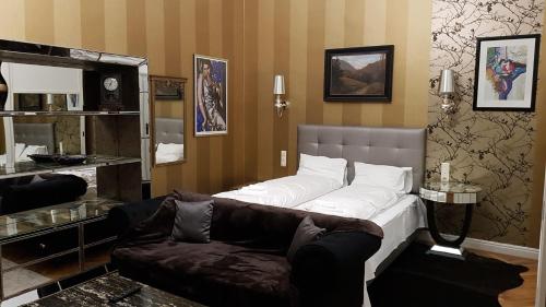 a living room with a bed and a couch at Boudoir Budapest Apartment in Budapest
