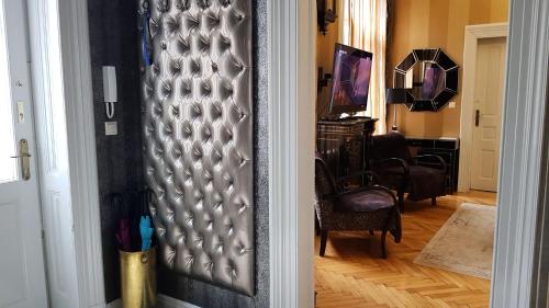 a hallway with a door leading to a living room at Boudoir Budapest Apartment in Budapest
